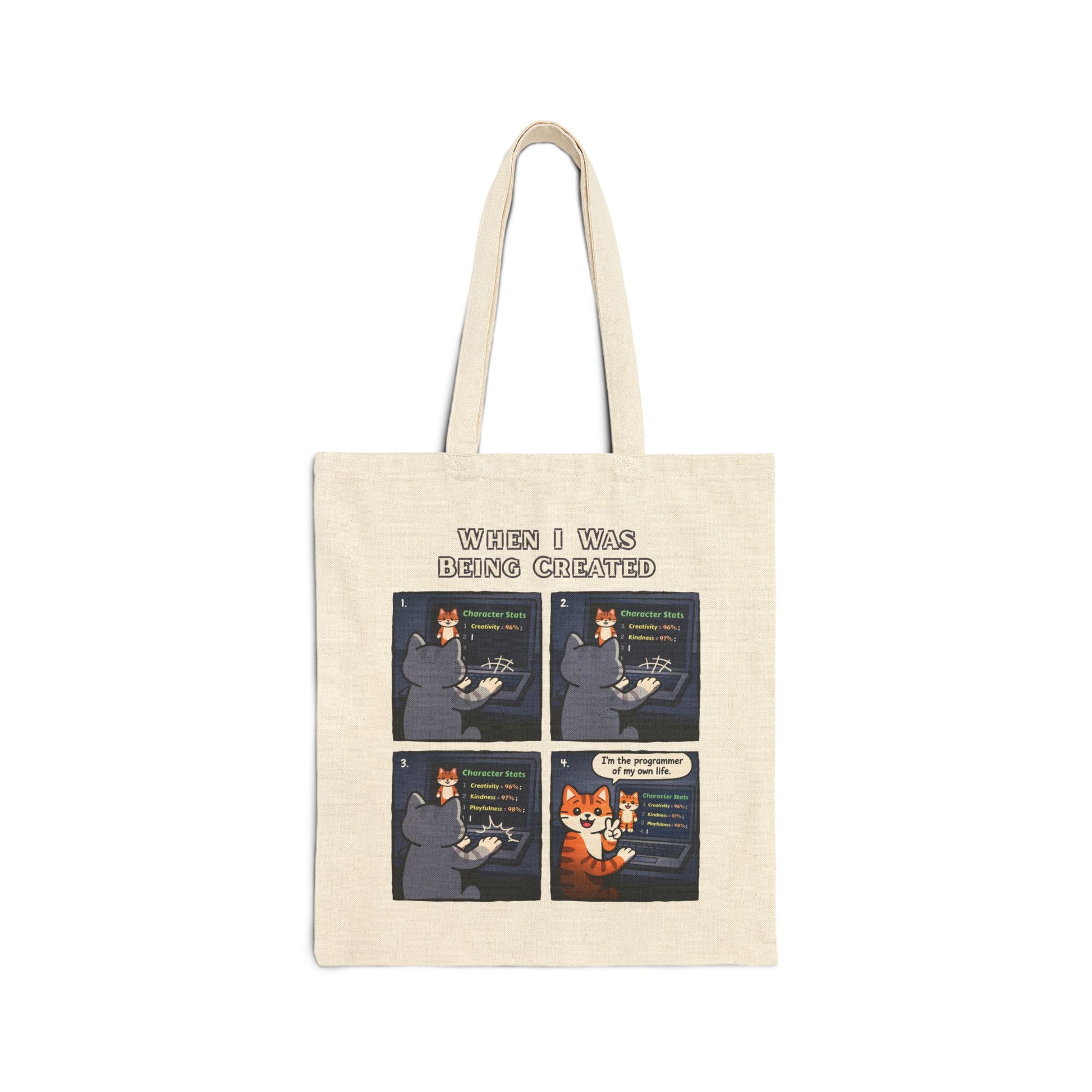 Tote bag with a 4-panel comic of a cartoon cat and title "When I Was Being Created" on a white background
