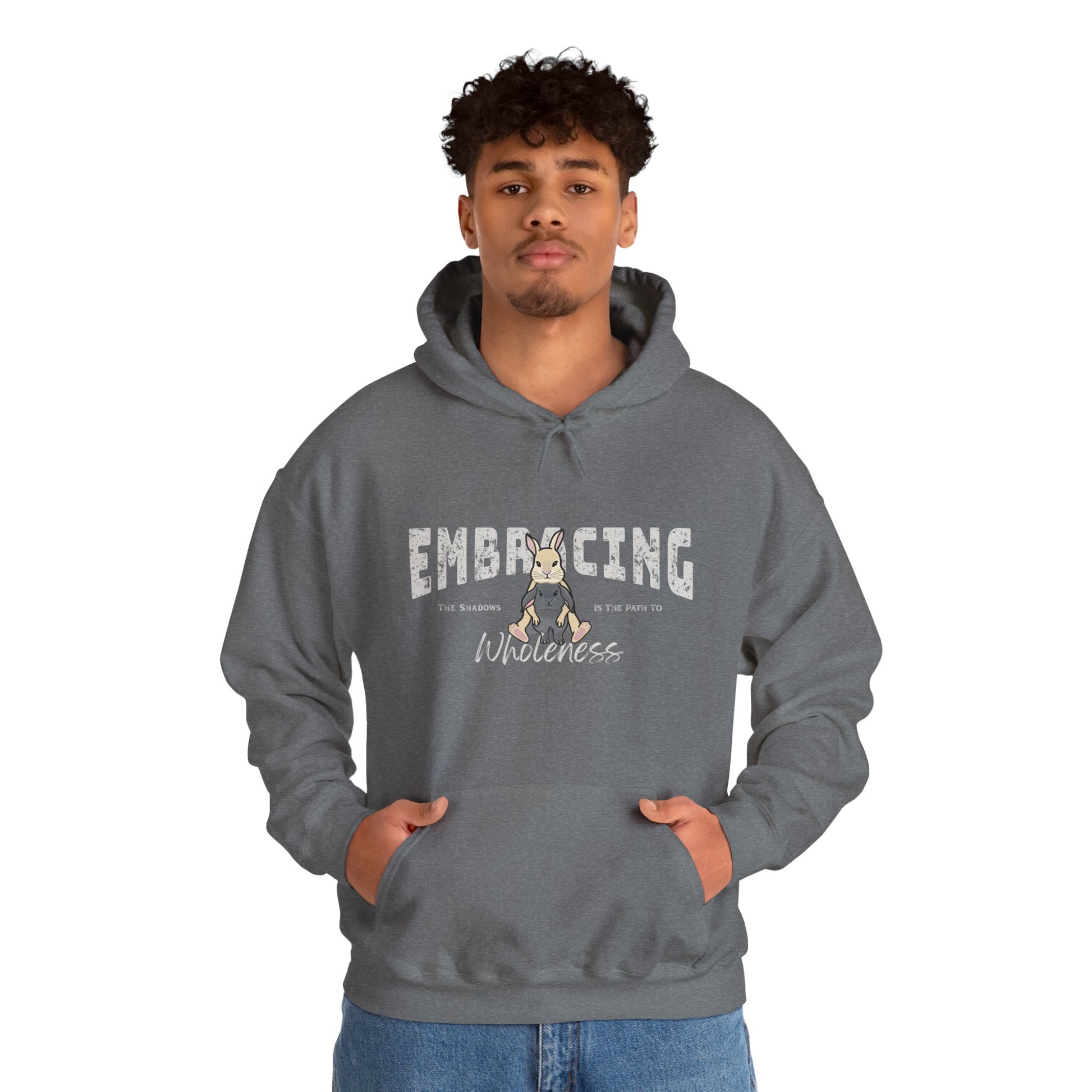Man wearing a blue-gray hoodie with a graphic of cream Holland Lop rabbit hugging gray Holland Lop rabbit and text 'Embracing the shadows is the path to wholeness' on a white background