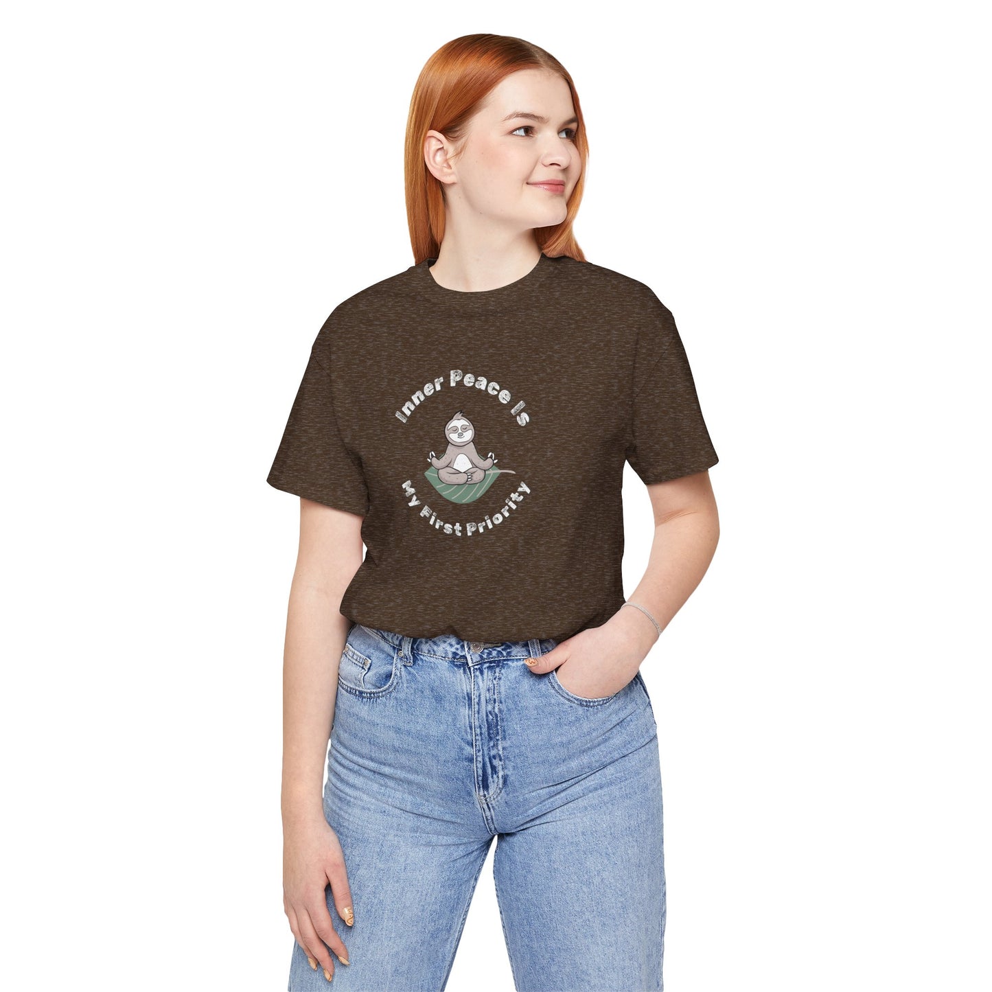 Woman wearing a brown t-shirt with a graphic of meditating sloth and text 'Inner peace is my first priority' on a white background