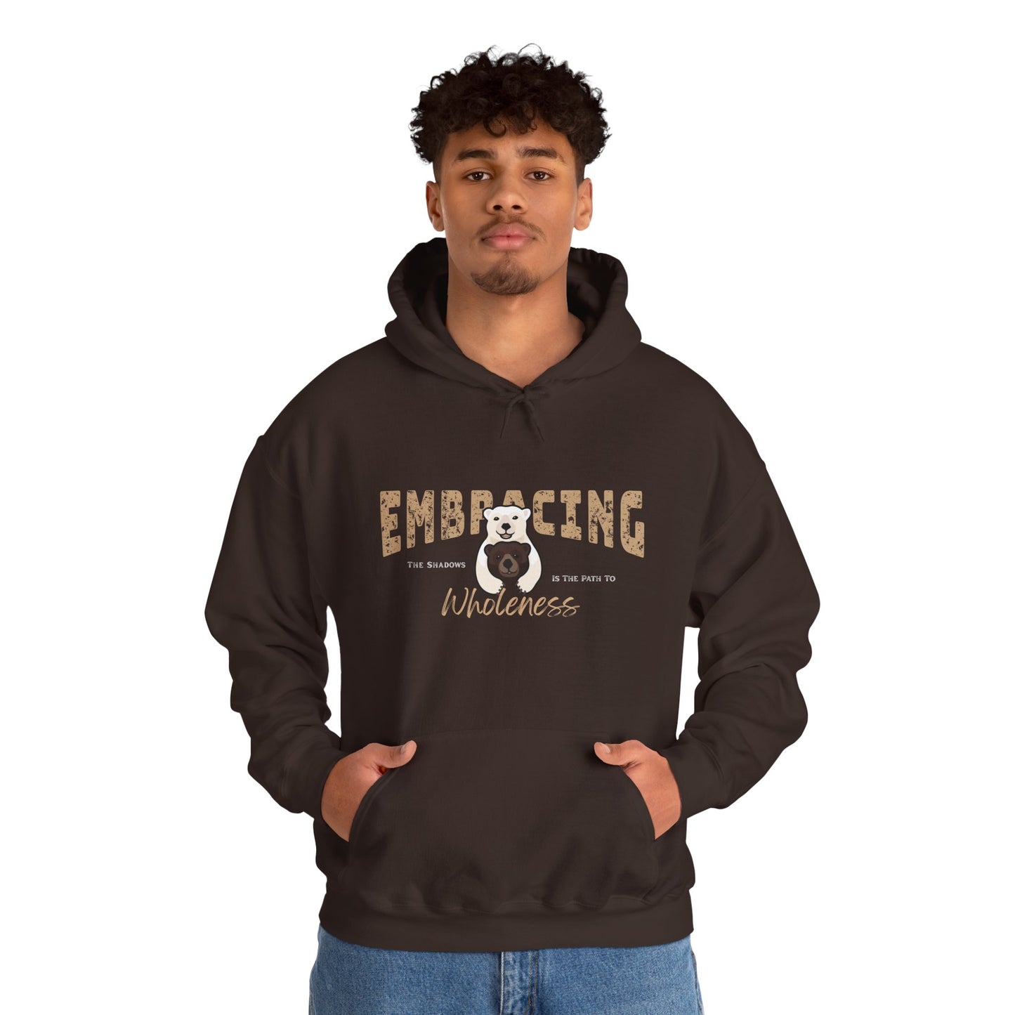 Man wearing a chocolate brown hoodie with a graphic of polar bear hugging brown bear and text 'Embracing the shadows is the path to wholeness' on a white background