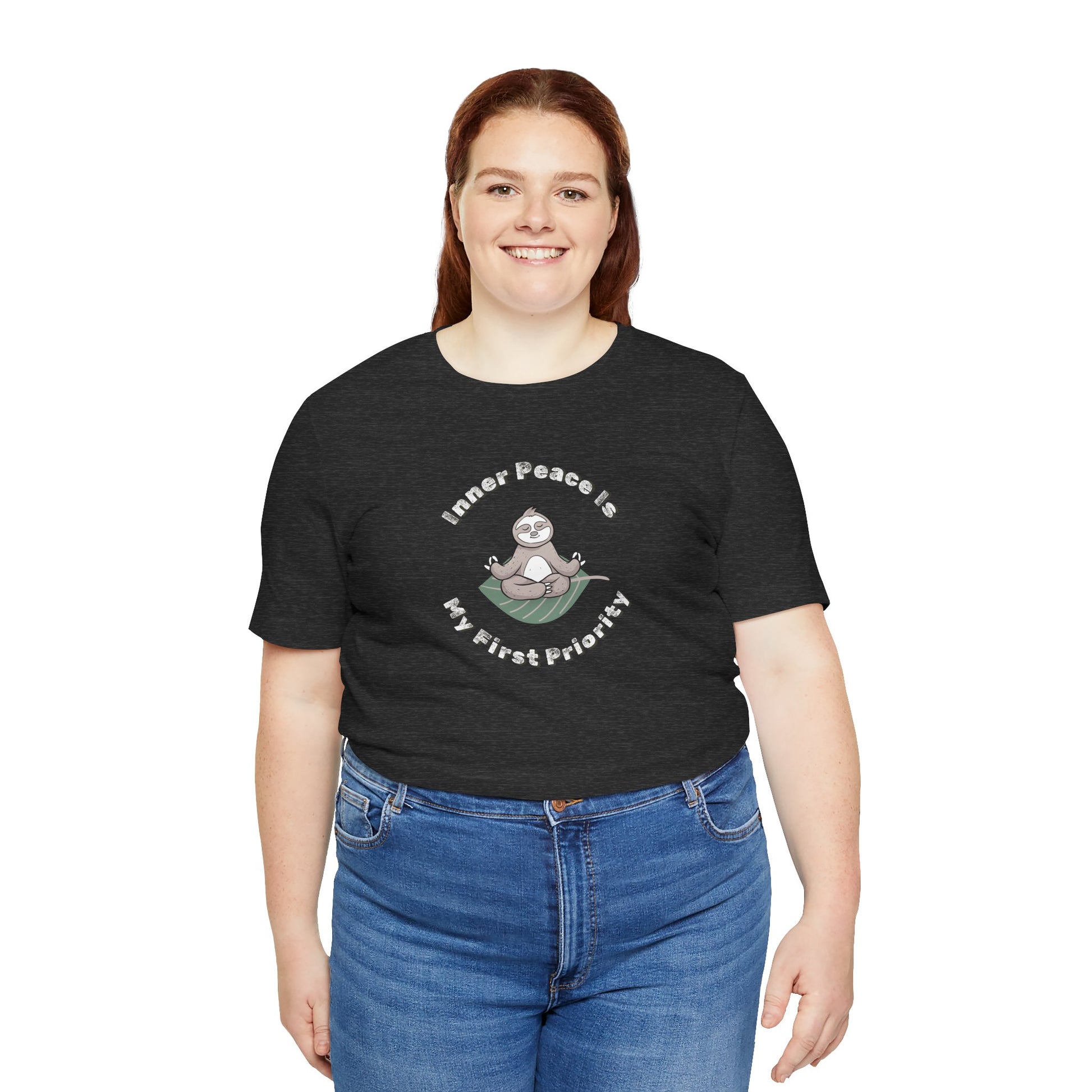 Woman wearing a black t-shirt with a graphic of meditating sloth and text 'Inner peace is my first priority' on a white background