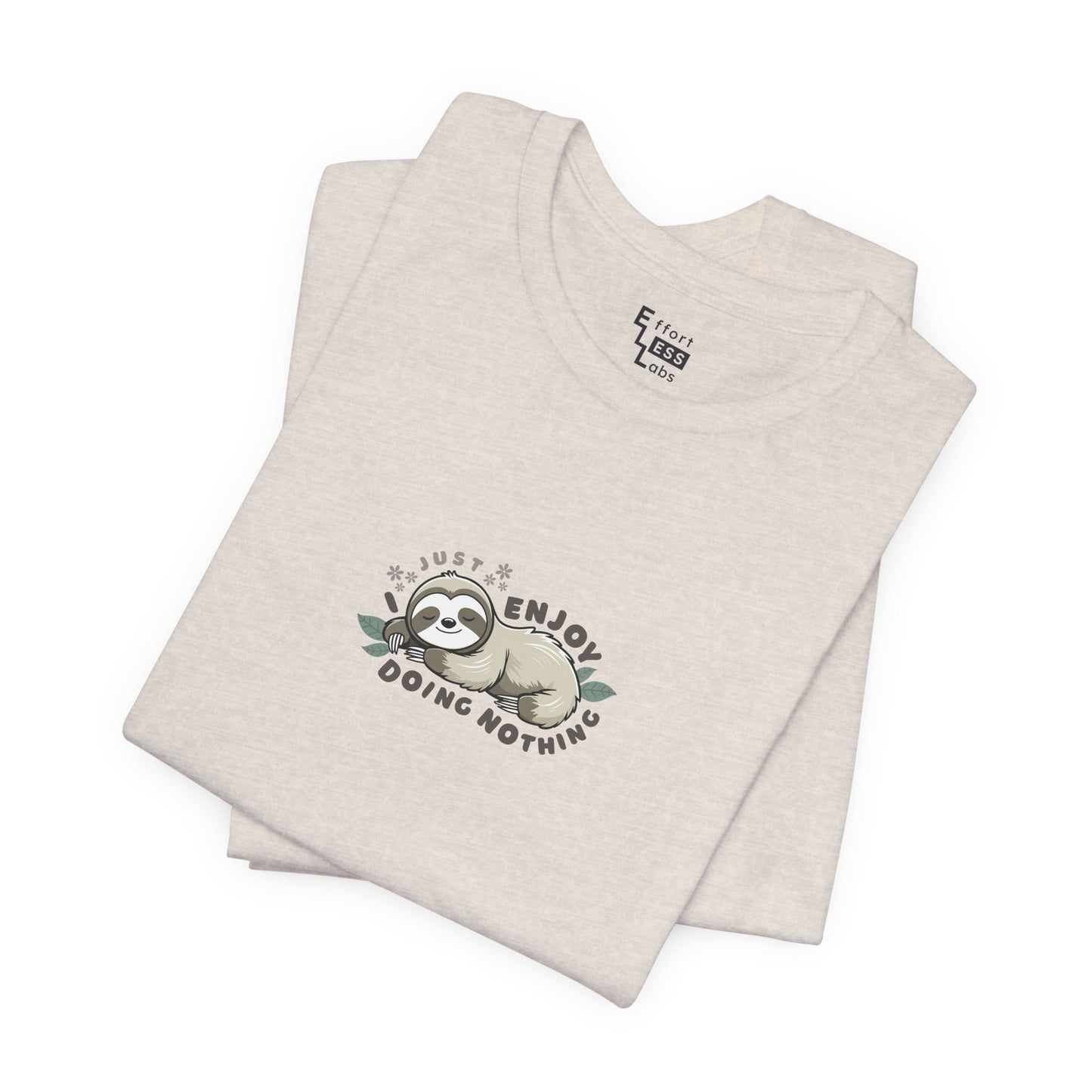 Folded almond beige t-shirt with a sloth graphic and text 'I just enjoy doing nothing' on a white background