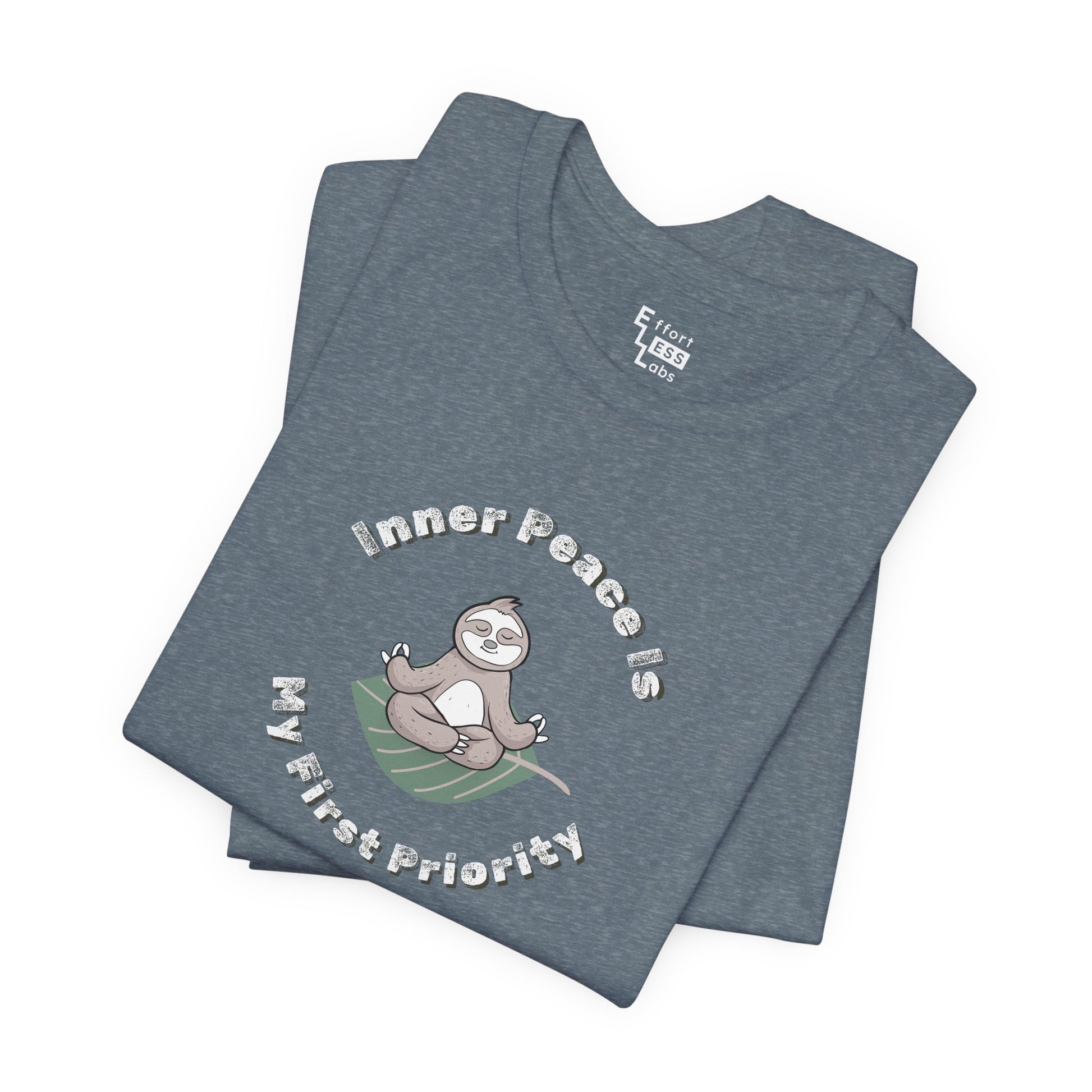 Folded blue t-shirt with a meditating sloth graphic and text 'Inner peace is my first priority' on a white background
