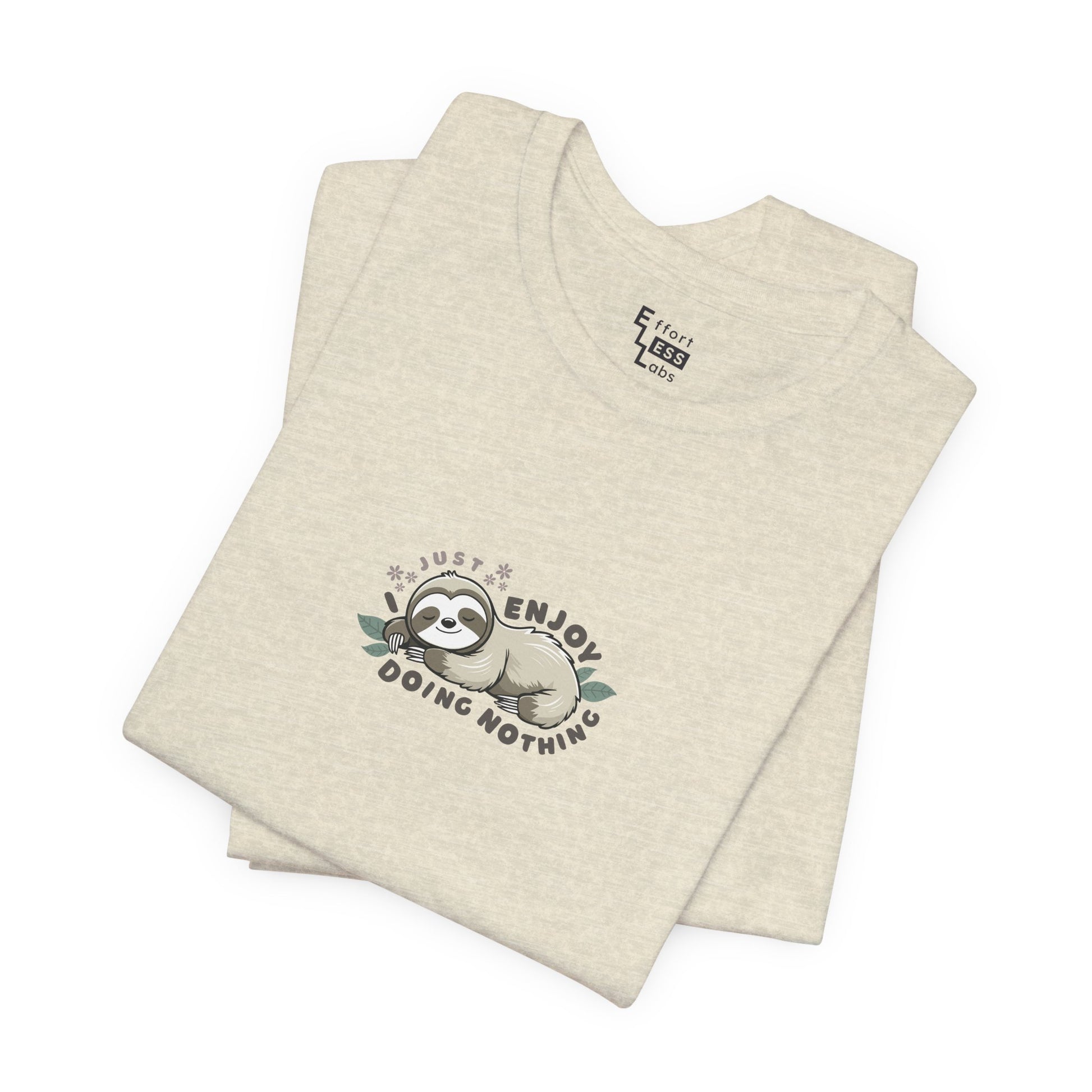 Folded cream beige t-shirt with a sloth graphic and text 'I just enjoy doing nothing' on a white background