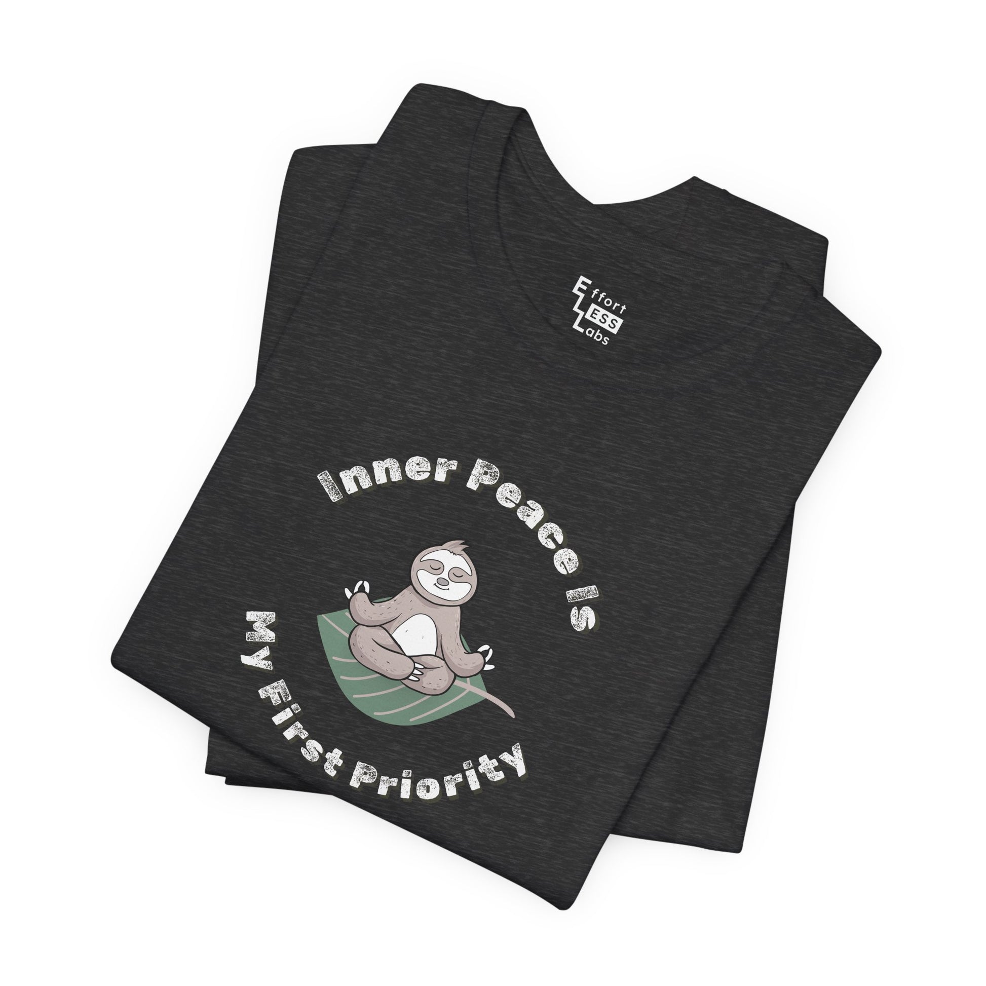Folded dark grey t-shirt with a meditating sloth graphic and text 'Inner peace is my first priority' on a white background