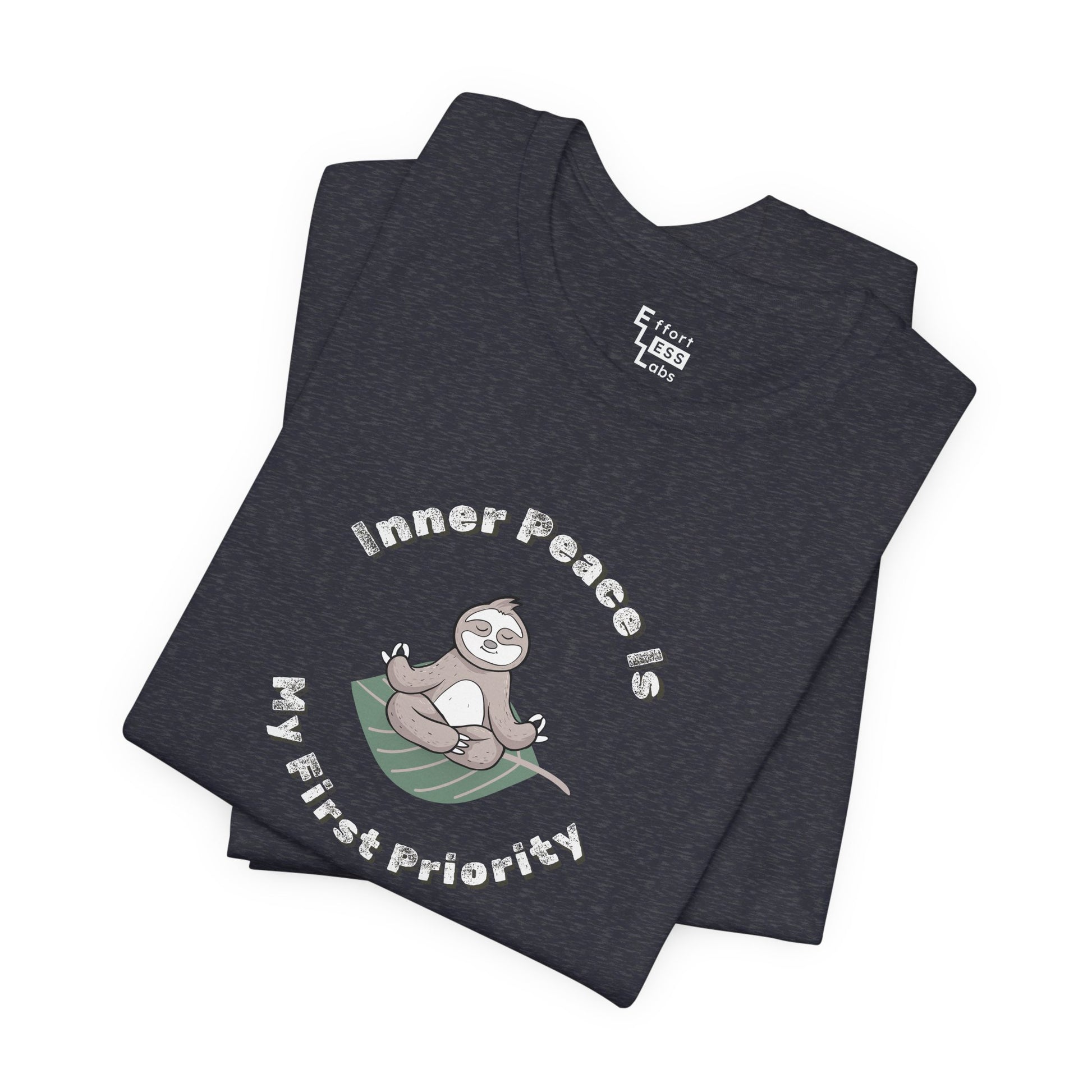 Folded navy t-shirt with a meditating sloth graphic and text 'Inner peace is my first priority' on a white background