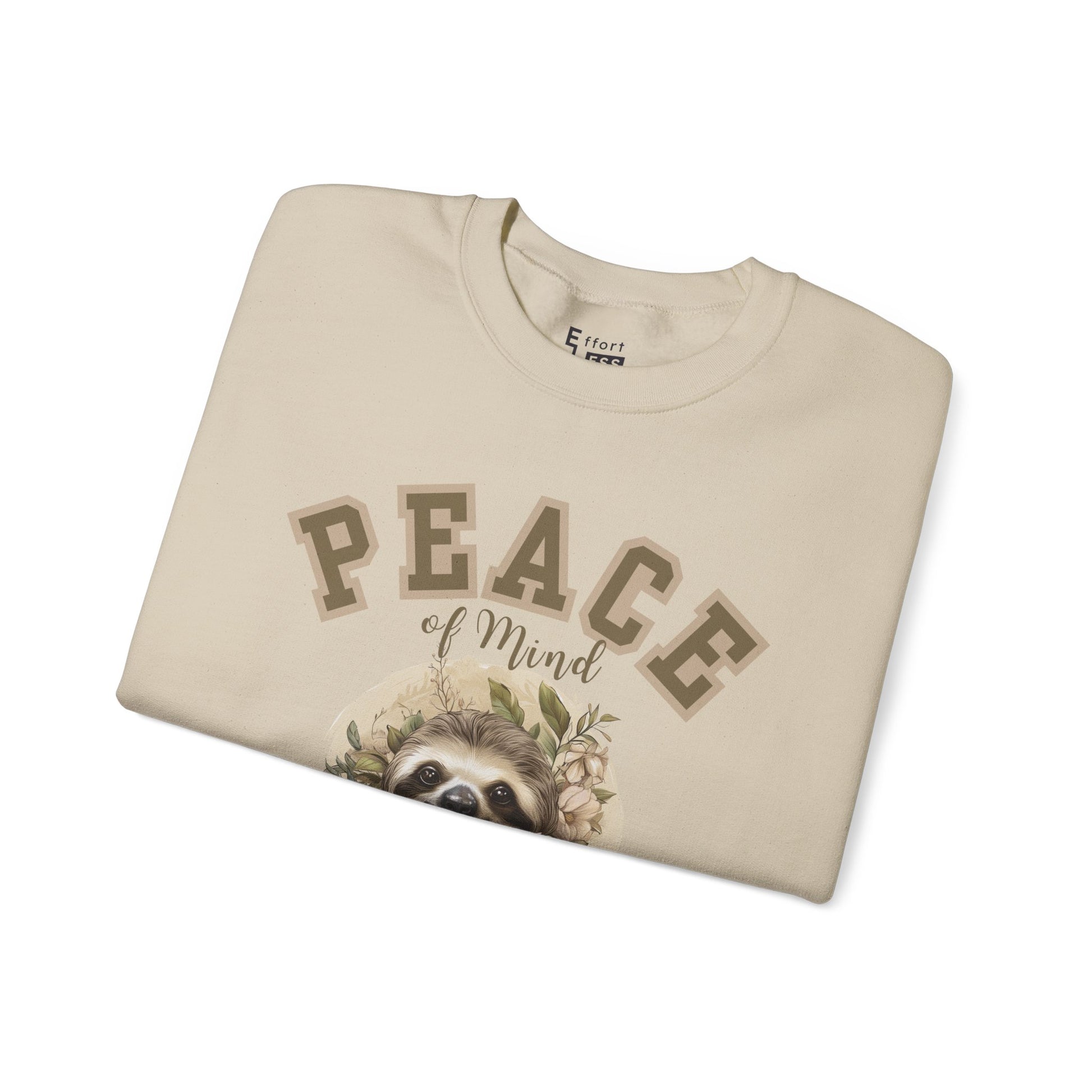 Folded sand beige sweatshirt with a floral sloth graphic and text 'Peace of Mind' on a white background