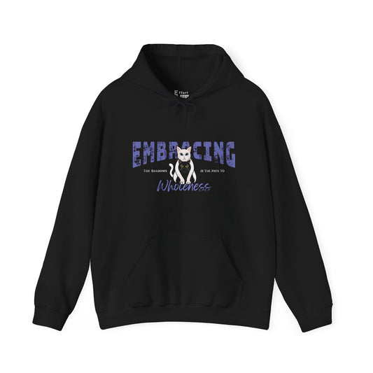 Black hoodie with a graphic of white cat hugging black cat and text 'Embracing the shadows is the path to wholeness' on a white background