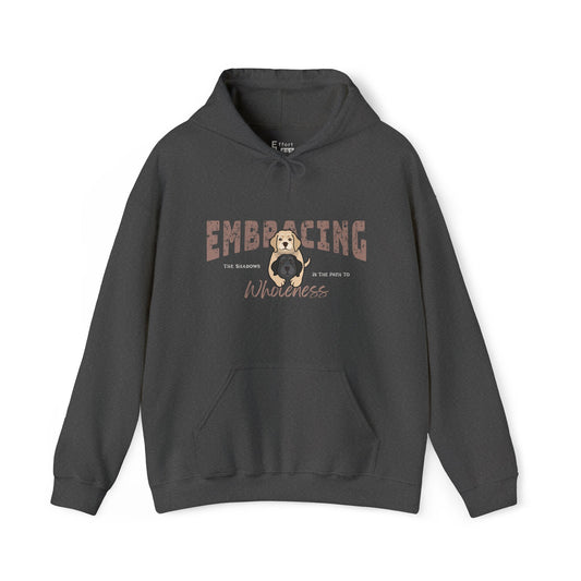 Dark gray hoodie with a graphic of yellow Labrador Retriever hugging black Labrador Retriever and text 'Embracing the shadows is the path to wholeness' on a white background
